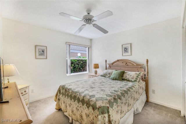 bedroom featuring light carpet and ceiling fan