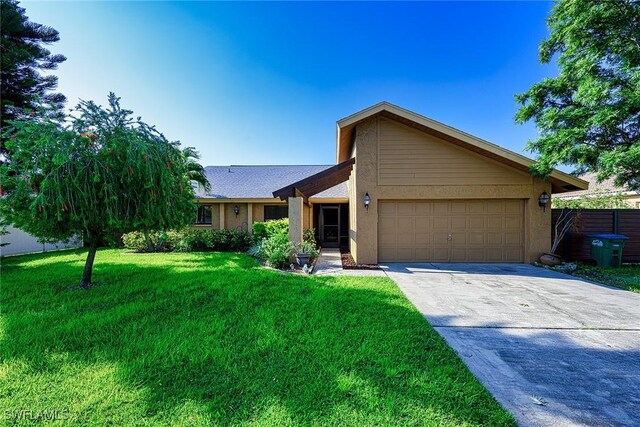 ranch-style home with a garage and a front lawn