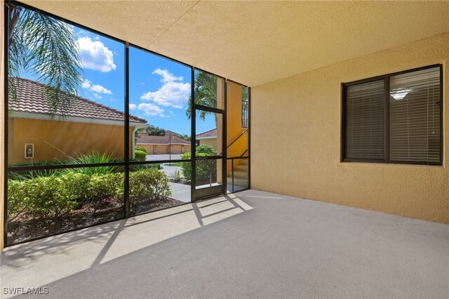 unfurnished sunroom with plenty of natural light