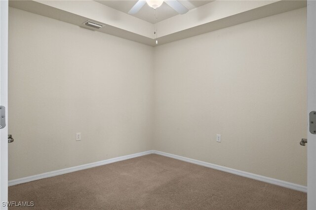 spare room featuring baseboards, visible vents, ceiling fan, and carpet flooring