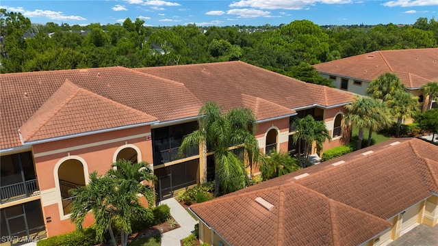 view of front facade featuring a tiled roof and stucco siding