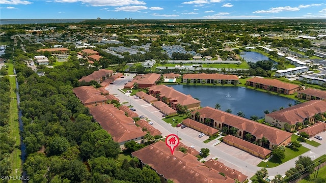 drone / aerial view with a water view and a residential view