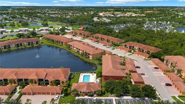 birds eye view of property with a water view and a residential view