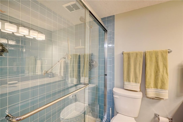 bathroom featuring toilet and walk in shower