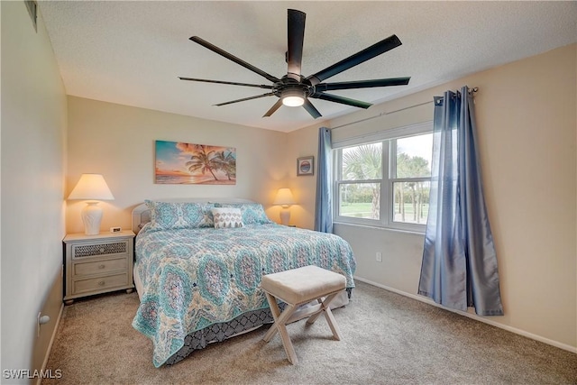 bedroom with light carpet, ceiling fan, and a textured ceiling