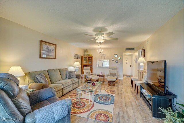 1828 Pine Valley Dr Unit 211, Fort Myers, FL 33907 - living room with visible vents, light wood-style floors, ceiling fan, and a textured ceiling