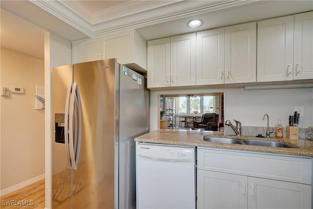 1828 Pine Valley Dr Unit 211, Fort Myers, FL 33907 - kitchen with white dishwasher, a sink, white cabinets, crown molding, and stainless steel fridge