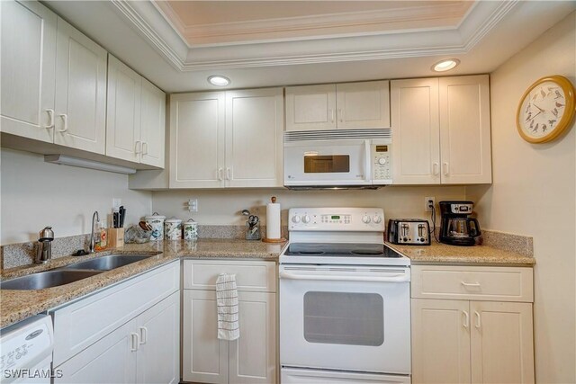 kitchen featuring white appliances, white cabinetry, sink, a raised ceiling, and ornamental molding