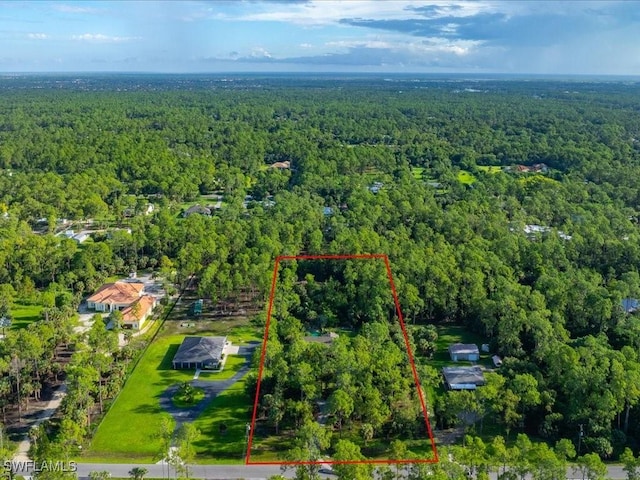 drone / aerial view featuring a view of trees