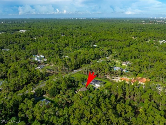 birds eye view of property featuring a view of trees