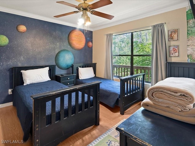 bedroom featuring ornamental molding, wood finished floors, a ceiling fan, and baseboards