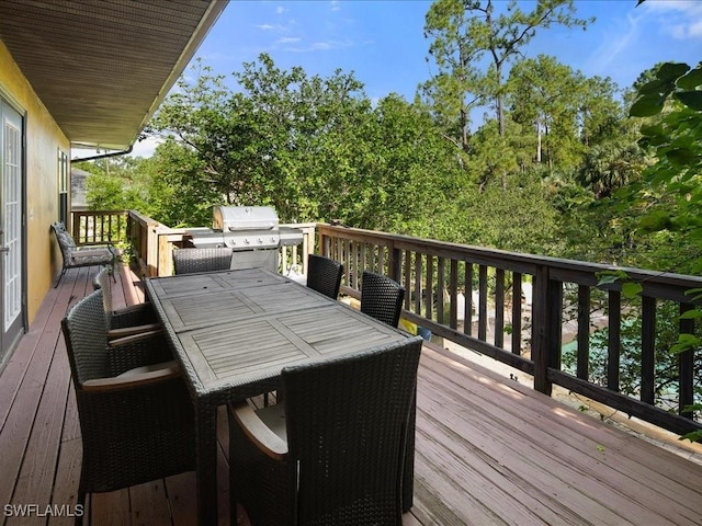 deck featuring outdoor dining space and area for grilling