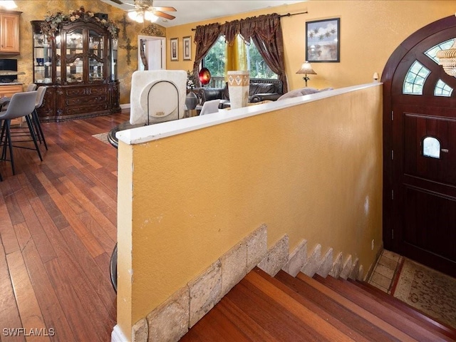 entryway with wood-type flooring and a ceiling fan