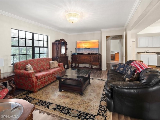 living room with ornamental molding and light wood-style flooring