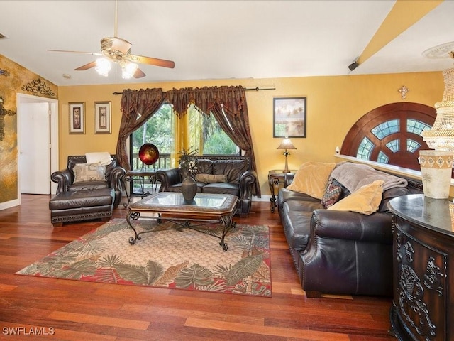 living room with a ceiling fan, lofted ceiling, baseboards, and wood finished floors