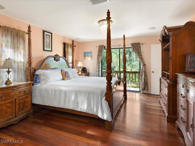 bedroom with access to outside, visible vents, and dark wood-type flooring