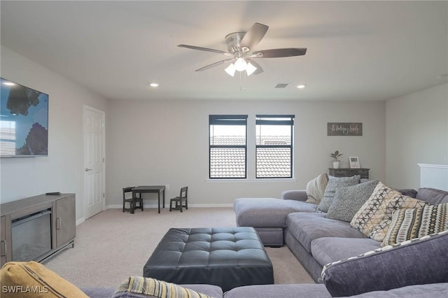 carpeted living room with ceiling fan