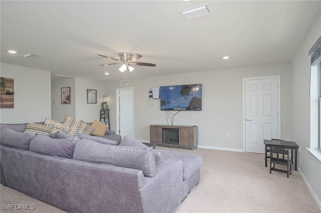 carpeted living room featuring ceiling fan