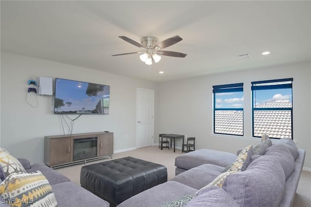 carpeted living room featuring ceiling fan