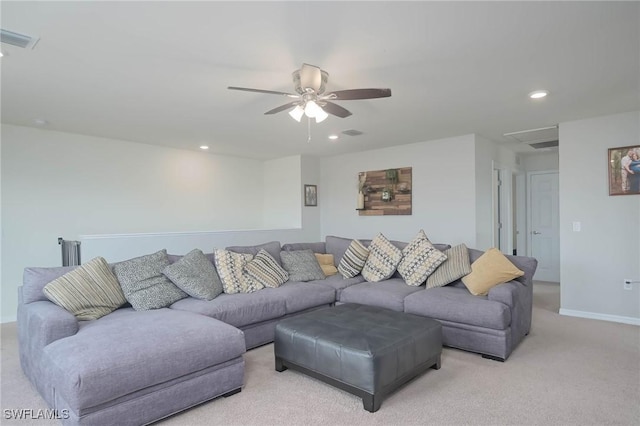 carpeted living room with ceiling fan