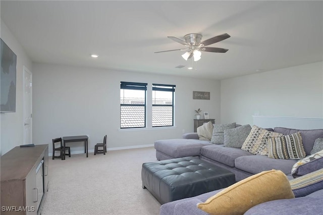 carpeted living room featuring ceiling fan