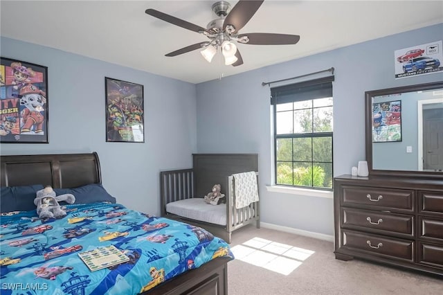 bedroom featuring light colored carpet and ceiling fan