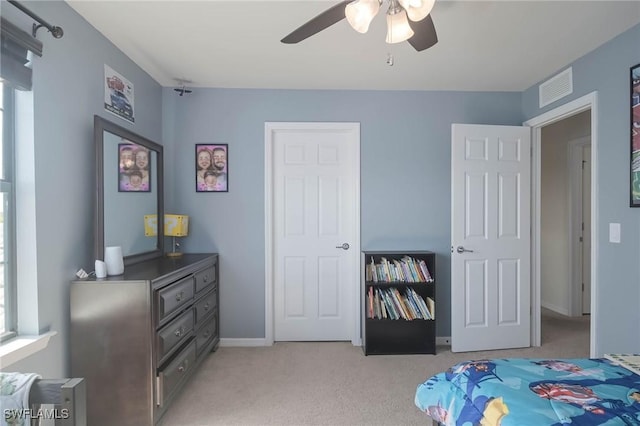 bedroom with light colored carpet and ceiling fan