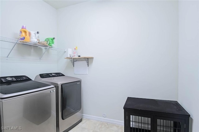 washroom featuring washer and dryer and light tile patterned floors