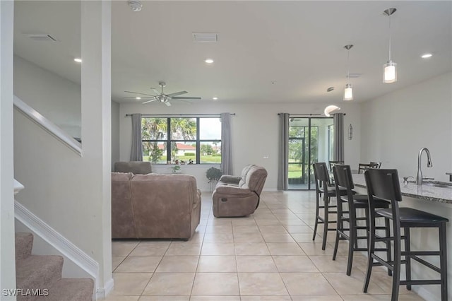 dining room with sink, ceiling fan, and light tile patterned flooring