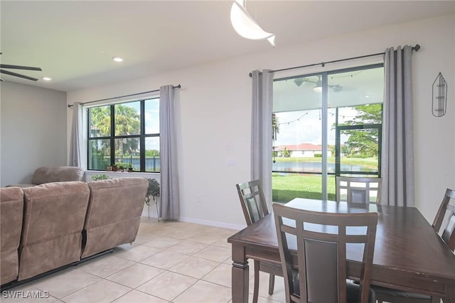 tiled dining area with ceiling fan