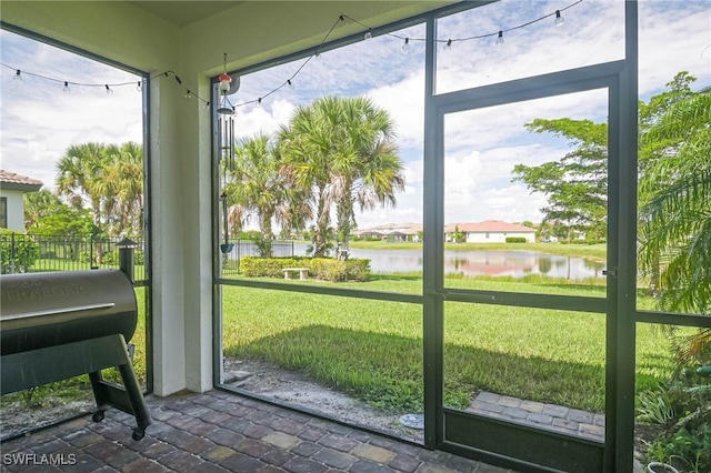 doorway to outside with a water view