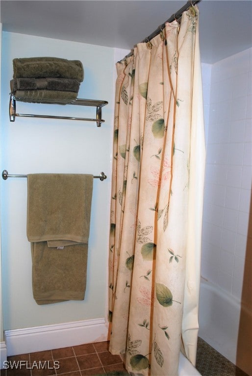 bathroom featuring tile patterned flooring and shower / bath combination with curtain