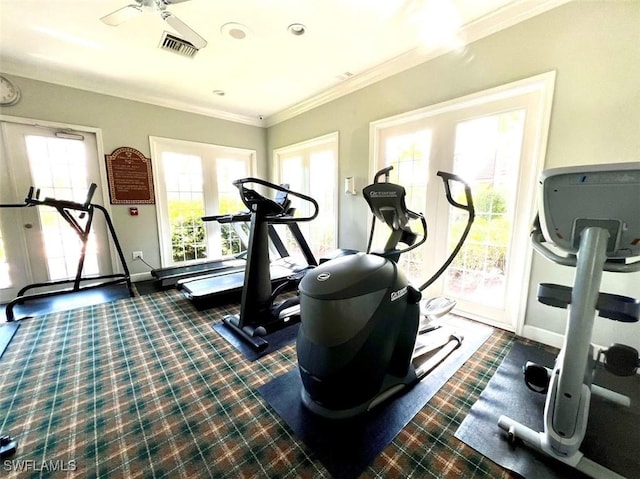 workout area featuring a ceiling fan, visible vents, crown molding, and baseboards