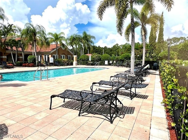 pool featuring a patio and fence