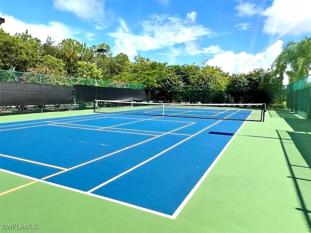 view of sport court featuring fence