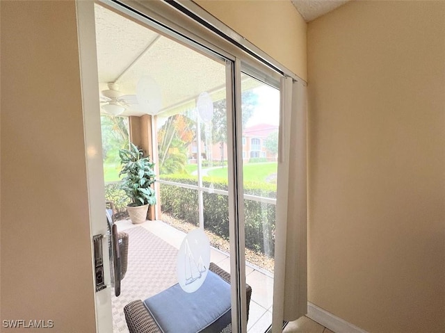 entryway featuring baseboards and a ceiling fan