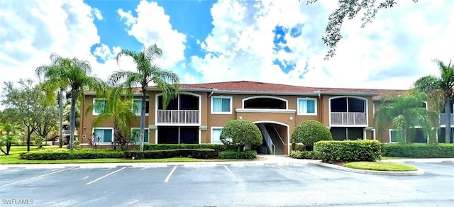 view of building exterior with uncovered parking