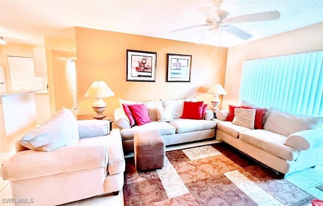 living room with ceiling fan and a textured ceiling