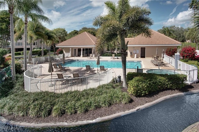 view of swimming pool with a patio area and a water view