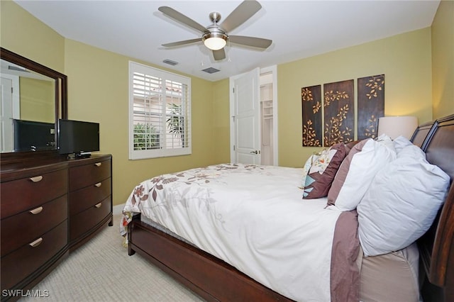 bedroom featuring ceiling fan and light carpet