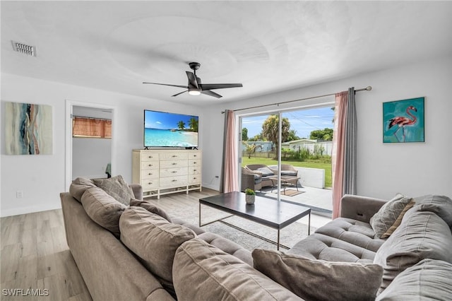 living room with light hardwood / wood-style floors and ceiling fan