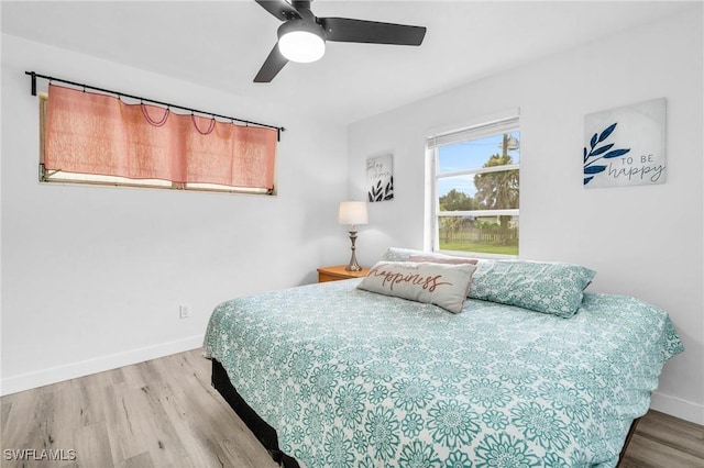 bedroom with ceiling fan and wood-type flooring