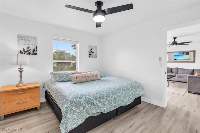 bedroom with ceiling fan and light wood-type flooring