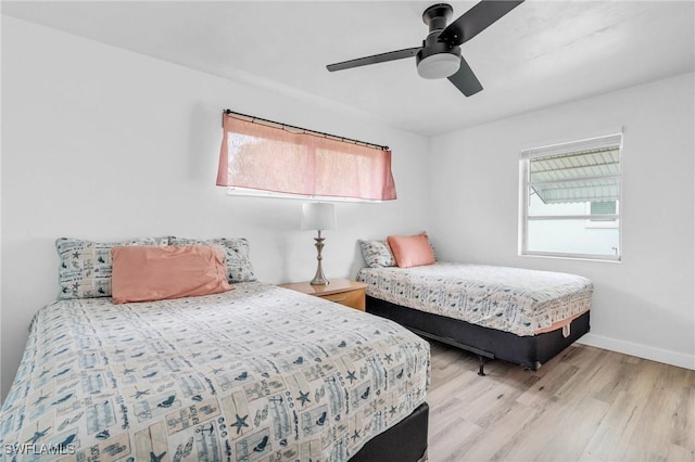 bedroom with light hardwood / wood-style floors and ceiling fan