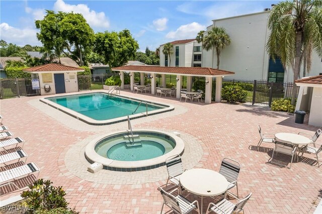 view of pool with a patio area and a community hot tub