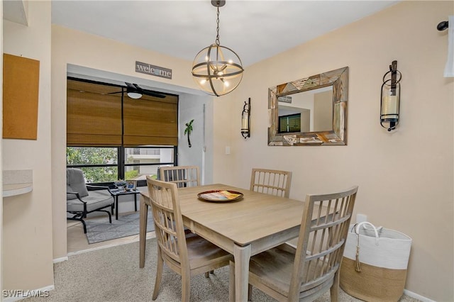 dining area with light carpet and a notable chandelier