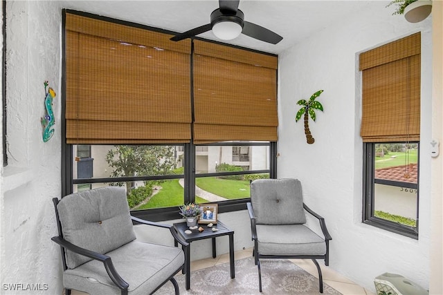 sunroom / solarium featuring a wealth of natural light and ceiling fan