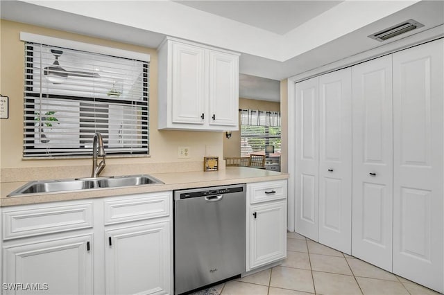 kitchen with sink, white cabinets, dishwasher, and light tile patterned flooring