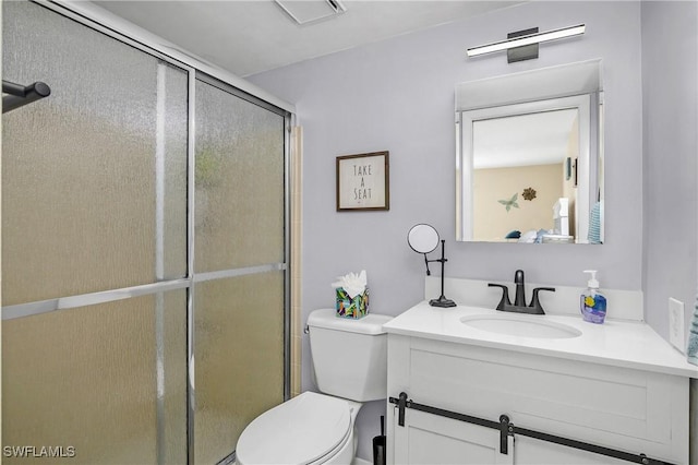 bathroom featuring vanity, toilet, and walk in shower