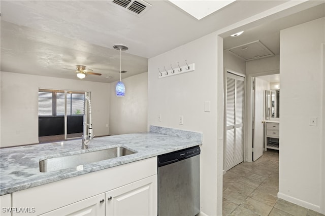 kitchen featuring light tile patterned flooring, white cabinetry, ceiling fan, stainless steel dishwasher, and sink